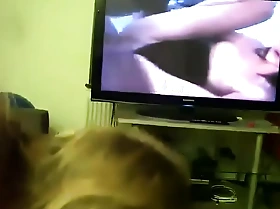 Mom gives son head while he watches porno